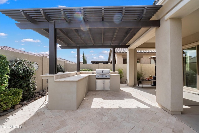 view of patio featuring exterior kitchen, a fenced backyard, grilling area, and a pergola