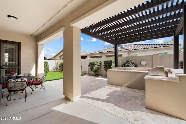 view of patio / terrace with outdoor dining area, an outdoor kitchen, a fenced backyard, and a pergola