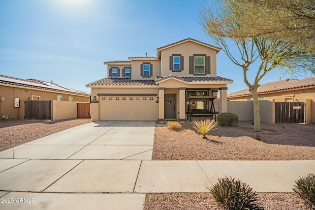 view of front facade with driveway, a tile roof, fence, and stucco siding