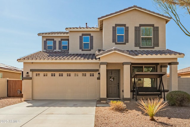 view of front of house with concrete driveway, an attached garage, and stucco siding