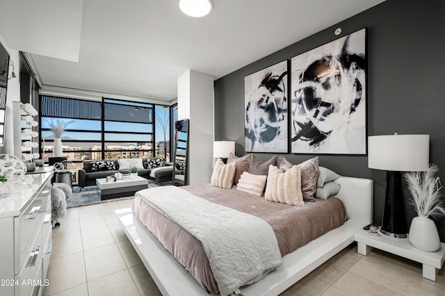 bedroom with light tile patterned floors and floor to ceiling windows