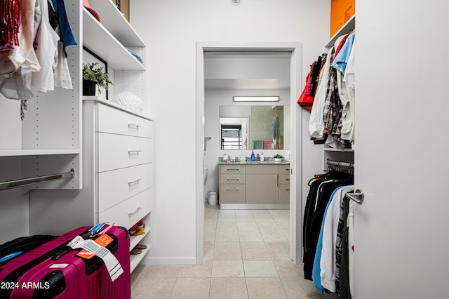 walk in closet with light tile patterned floors