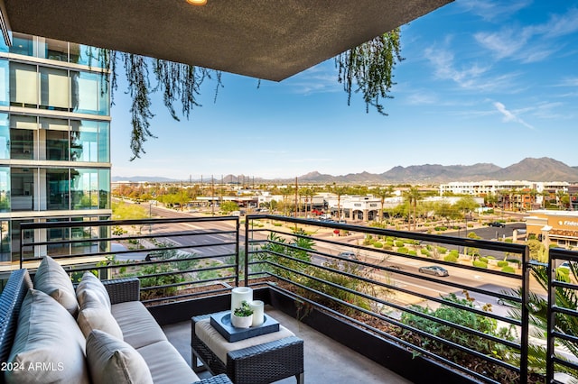 balcony featuring a mountain view and an outdoor hangout area