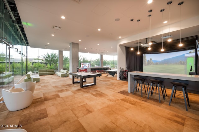 recreation room with recessed lighting, visible vents, and floor to ceiling windows