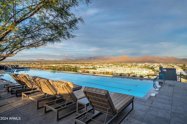 community pool with a mountain view