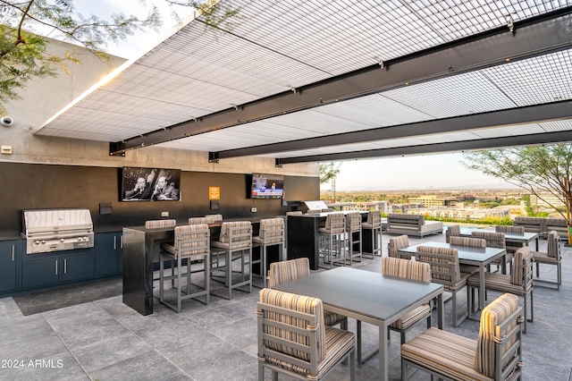 view of patio / terrace featuring exterior kitchen, outdoor wet bar, a grill, and an outdoor living space