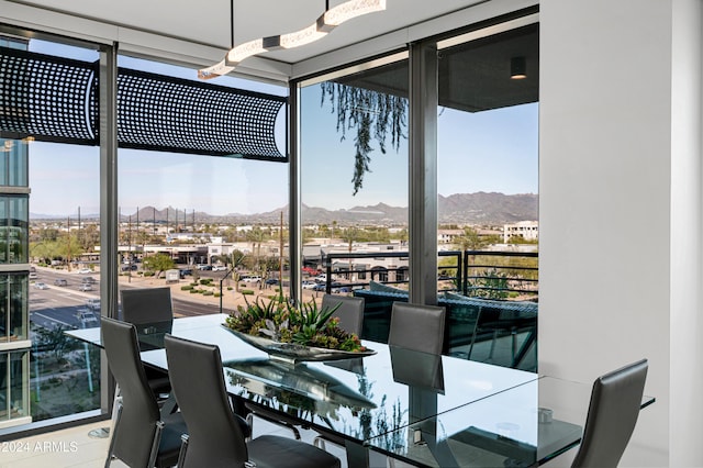 dining room featuring expansive windows and a mountain view