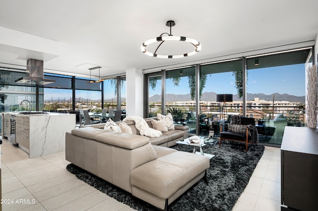 living area with light tile patterned floors, floor to ceiling windows, and a mountain view