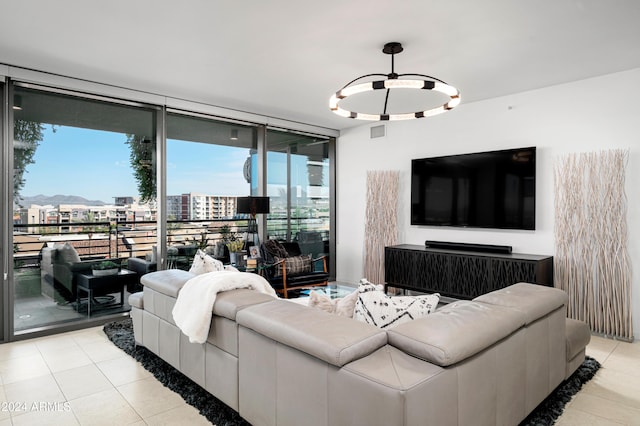 living area featuring light tile patterned floors, visible vents, and a wall of windows