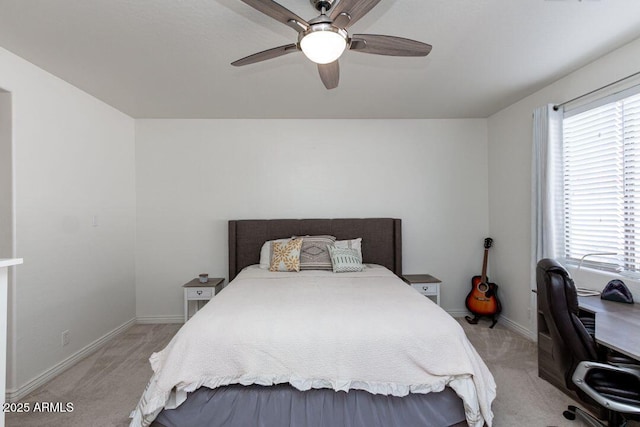 carpeted bedroom featuring ceiling fan and multiple windows