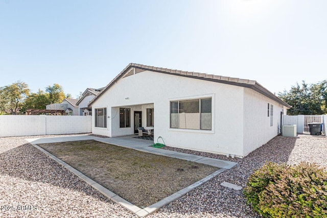 rear view of property featuring a patio and cooling unit