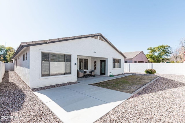 back of house with a patio