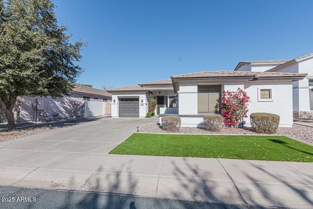 view of front of home with a garage and a front lawn