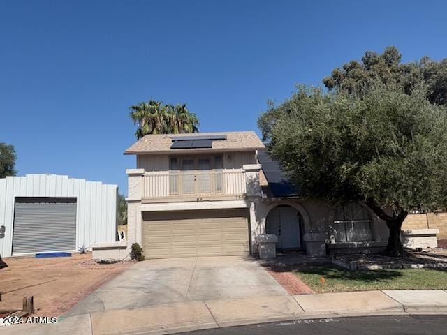 view of front of property featuring a balcony and solar panels