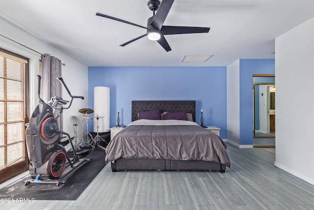 bedroom with ceiling fan and hardwood / wood-style flooring