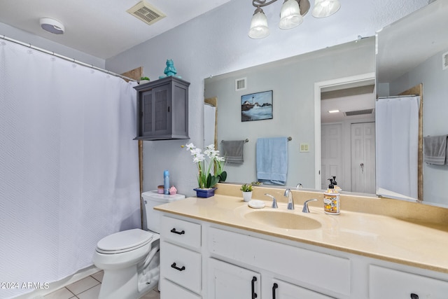 bathroom with toilet, tile patterned floors, and vanity