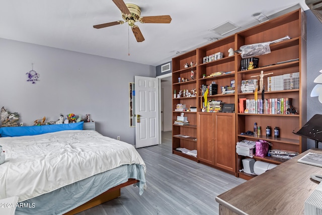 bedroom with ceiling fan and light hardwood / wood-style flooring