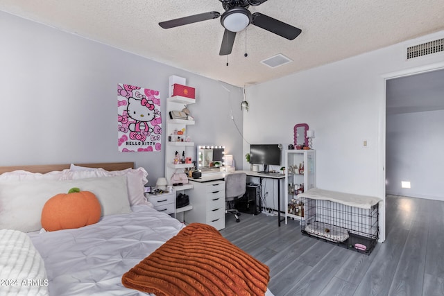 bedroom featuring ceiling fan, dark wood-type flooring, and a textured ceiling