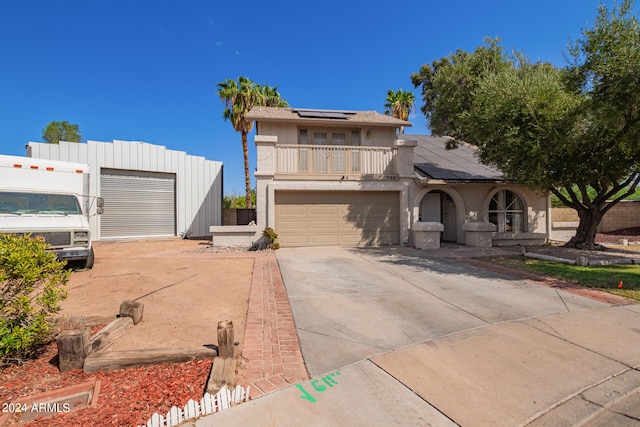 view of front of house featuring a balcony and solar panels