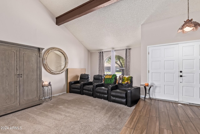 carpeted living room featuring a textured ceiling and lofted ceiling with beams