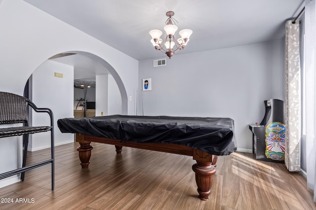 recreation room with pool table, wood-type flooring, and a notable chandelier