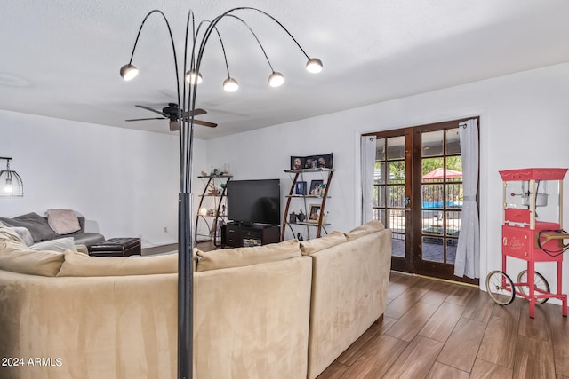 living room featuring ceiling fan and french doors