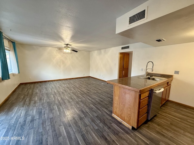 kitchen with ceiling fan, dishwasher, kitchen peninsula, sink, and dark wood-type flooring