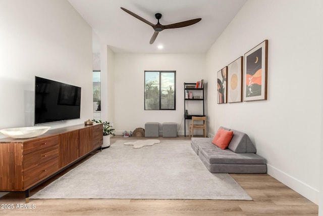 living area with a ceiling fan, light wood-style floors, and recessed lighting