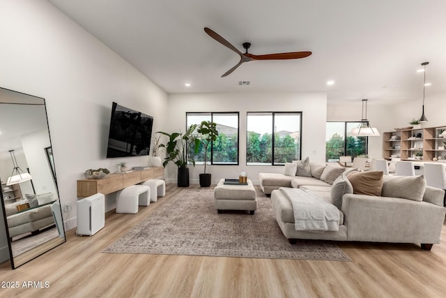 living room with ceiling fan, wood finished floors, and recessed lighting