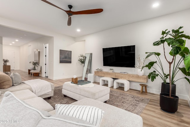 living area with a ceiling fan, wood finished floors, baseboards, and recessed lighting