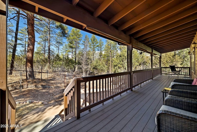 wooden terrace featuring fence