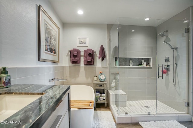 full bath with recessed lighting, vanity, and a shower stall