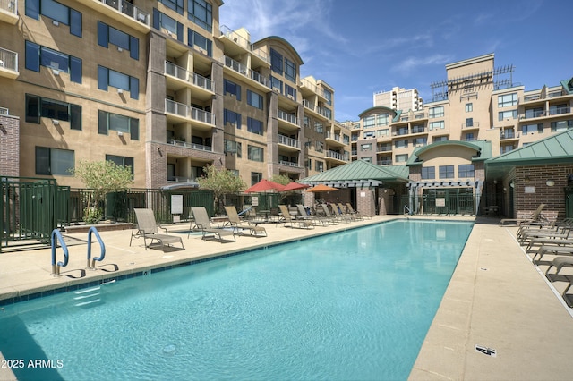 community pool featuring a patio area and fence