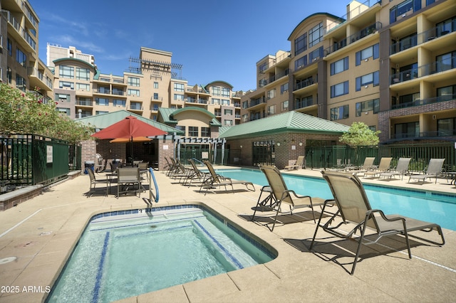 community pool featuring a patio area and fence