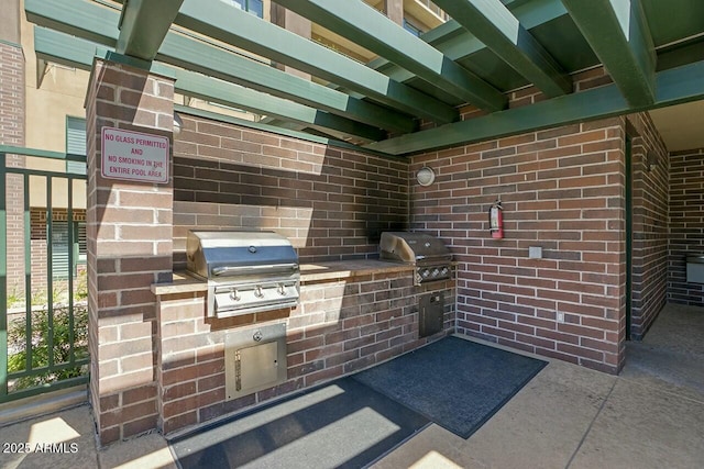 view of patio with area for grilling and an outdoor kitchen