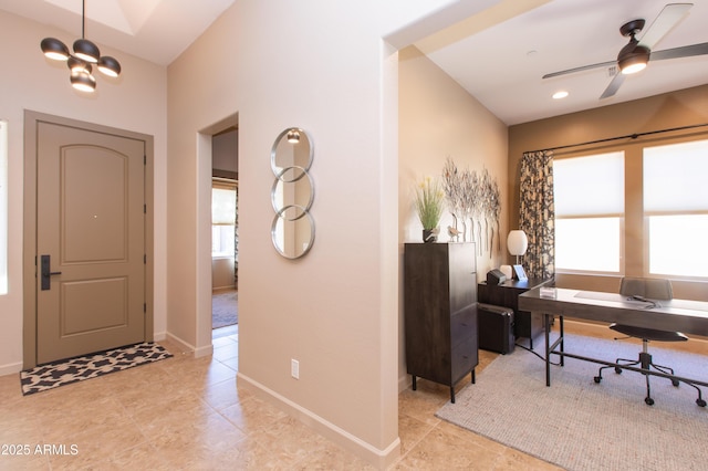 office space with light tile patterned floors and ceiling fan with notable chandelier