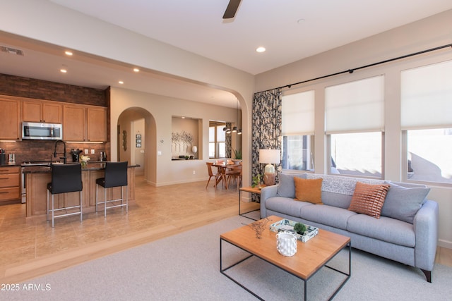 living room featuring ceiling fan and light wood-type flooring