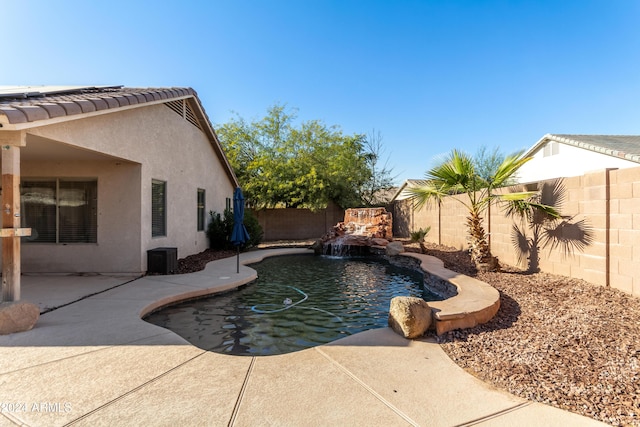 view of pool featuring pool water feature and a patio