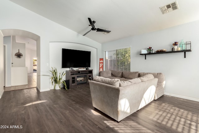 living room with vaulted ceiling, ceiling fan, a fireplace, and dark hardwood / wood-style floors