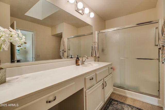 bathroom with walk in shower and vanity