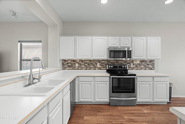 2834 E Devon Ct, Gilbert, AZ 85296 - kitchen featuring appliances with stainless steel finishes, decorative backsplash, white cabinetry, recessed lighting, and light countertops