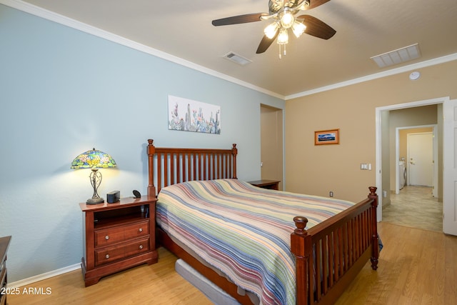 bedroom featuring ceiling fan, light hardwood / wood-style floors, and ornamental molding