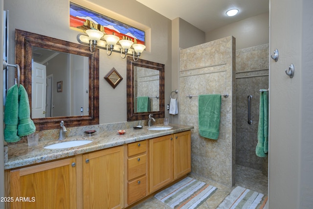 bathroom featuring vanity, tile patterned floors, and a tile shower