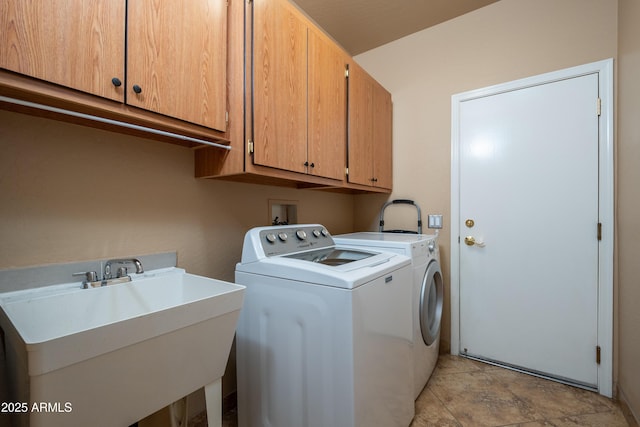 laundry room with cabinets, sink, and washing machine and dryer