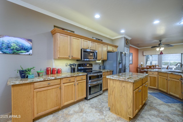 kitchen featuring ceiling fan, a kitchen island, sink, stainless steel appliances, and light stone counters