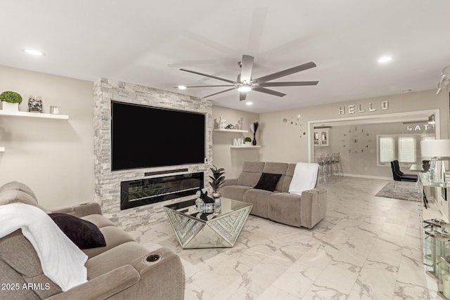 living room featuring a fireplace and ceiling fan