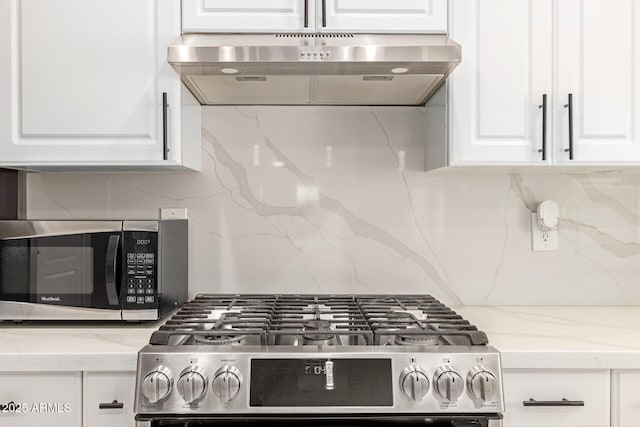 kitchen featuring backsplash, white cabinets, and stainless steel appliances