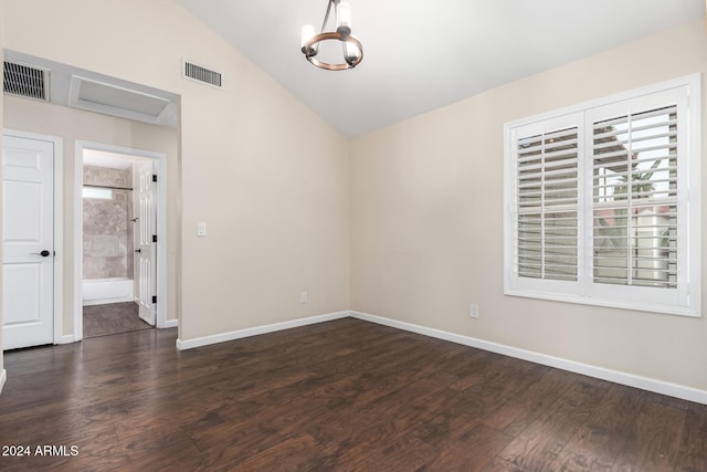 unfurnished room featuring a chandelier, dark hardwood / wood-style flooring, and vaulted ceiling