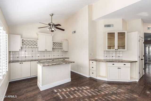 kitchen with tasteful backsplash, white cabinetry, a center island, and ceiling fan