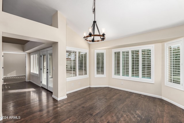 unfurnished room featuring a notable chandelier, dark hardwood / wood-style flooring, and vaulted ceiling